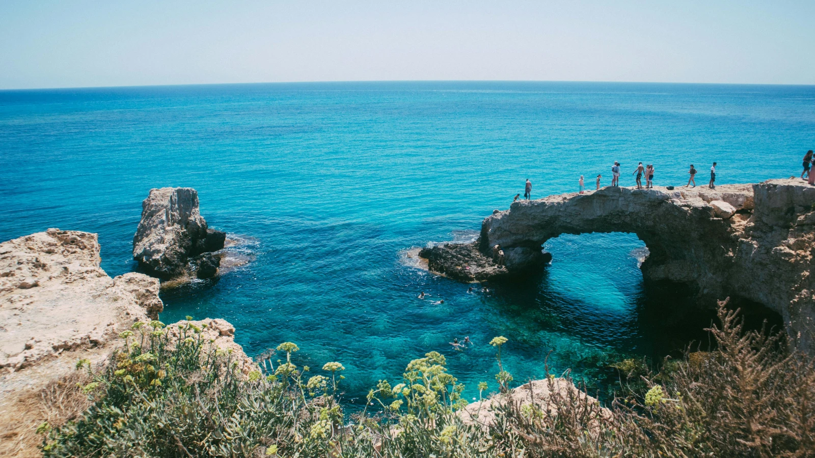 Tourists enjoying scenic Ayia Napa coastline on a car rental road trip in Cyprus